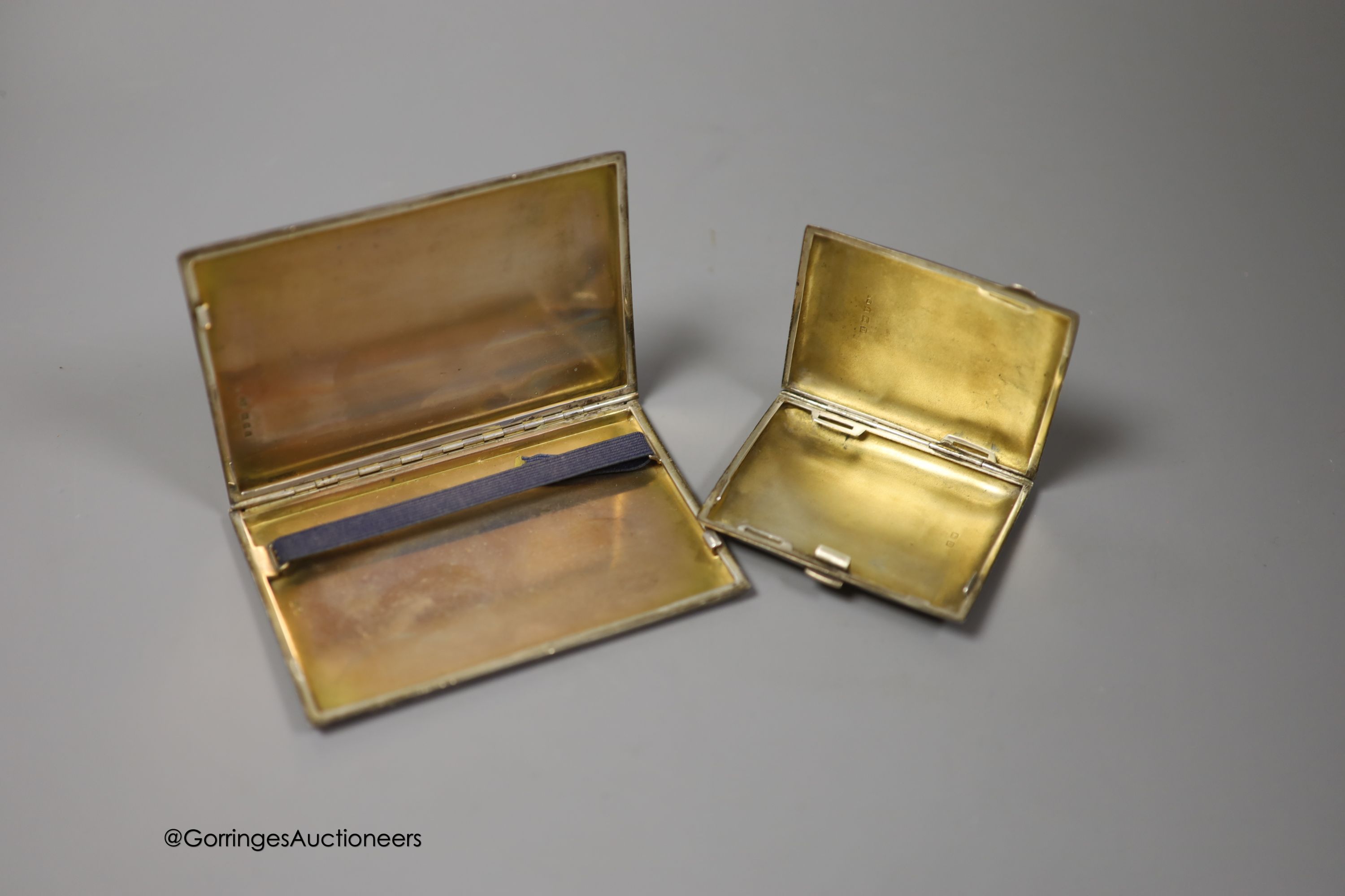 A George VI engine turned silver rectangular cigarette case, Goldsmiths & Silversmiths Co Ltd, London, 1940, 12.3cm and one other smaller silver cigarette case, gross 8.5oz.